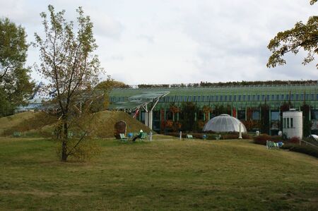 modern futuristic park lawn and trees modern green building with a glass domeの写真素材