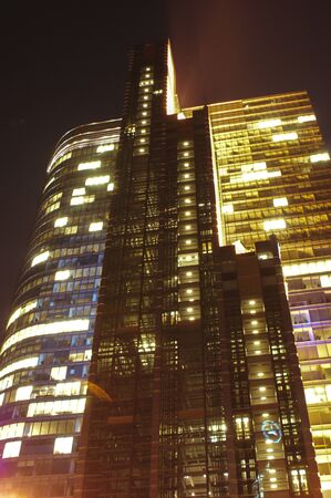 skyscraper skyscraper tall building at night illuminated office lights very tall glassの写真素材