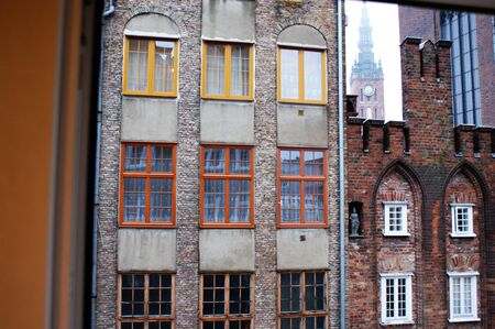 Old town square buildings lit by the sun in a row, in the market square Gdansk, Poland three...