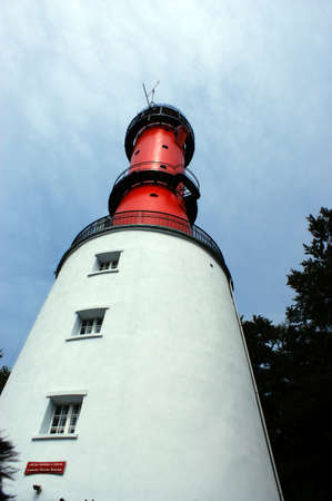 white lighthouse in poland blue sky and windows in a rowの写真素材