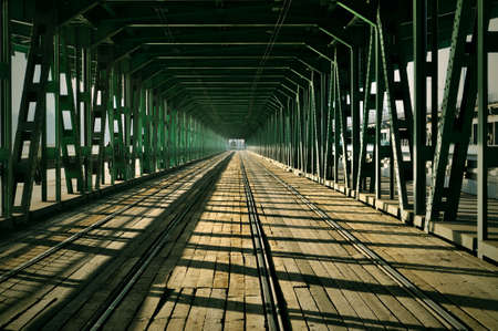 railway tram bridge over the river green iron trusses and wood in Warsaw Polandの写真素材