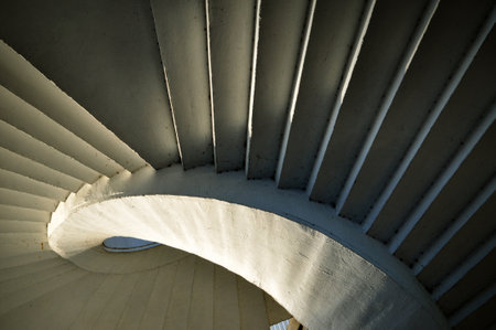 spiral concrete stairs from below and shadows of artistic architecture in Warsaw Poland
