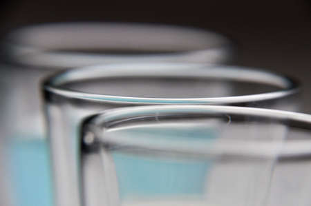 three glasses with colorful drinks blue white yellow closeupの写真素材