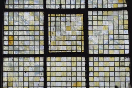 Colorful opaque milky glass mosaic window in a black frame, Poland