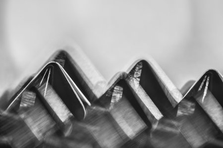 Close-up macro of sewing studs arranged in symmetrical rows in black and white abstraction