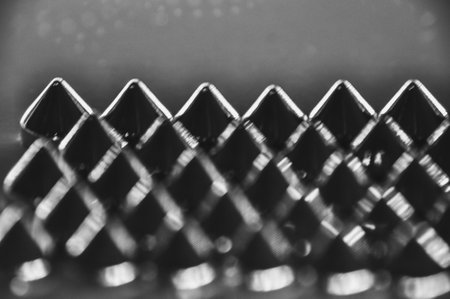 Close-up macro of sewing studs arranged in symmetrical rows in black and white abstractionの写真素材