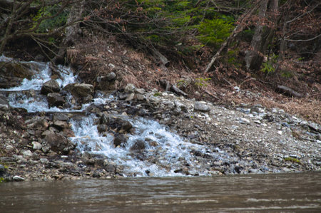 Small waterfall on a rocky riverbank on a cloudy day Tatra Poland