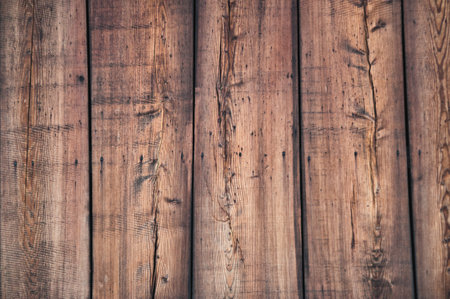 Wooden wall made of brown planks, facade of an old building wallの写真素材