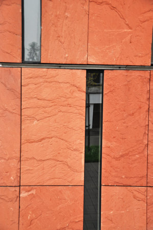 Red brick facade with narrow windows of a modern building, modern architectureの写真素材