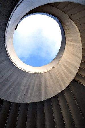 spiral concrete stairs from below and shadows of artistic architecture in Warsaw Poland
