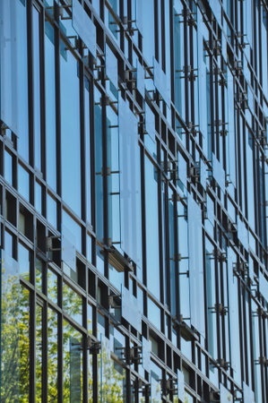 blue glass wall of office building mirror reflection cityscape