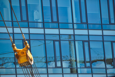glass office building blue architecture office district crane machine windows reflection