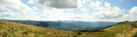 Panoramic picture of Bieszczady mountains, Bieszczady National Park, empty road leading towards mountain peaks beauty in natureの写真素材