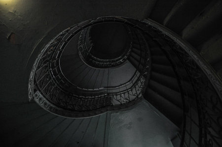 Staircase with winding stairs, delicate light darkの写真素材