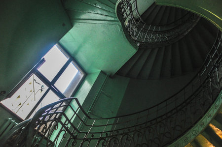 Green staircase with winding stairs, natural delicate light from windowの写真素材