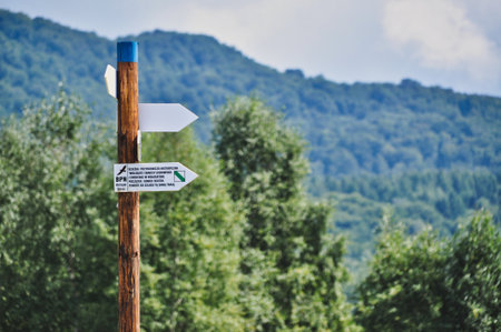 Wooden road sign in the mountains in Bieszczady, in the Bieszczady National Park Indicates the wayの写真素材