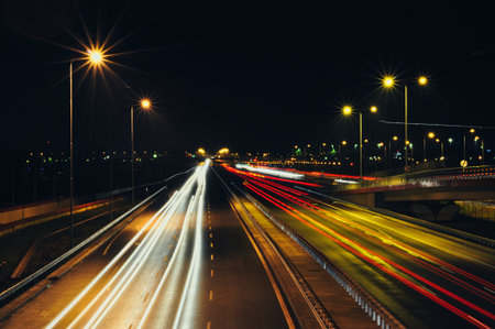This captivating night photography utilizes a long exposure technique to transform moving vehicles...