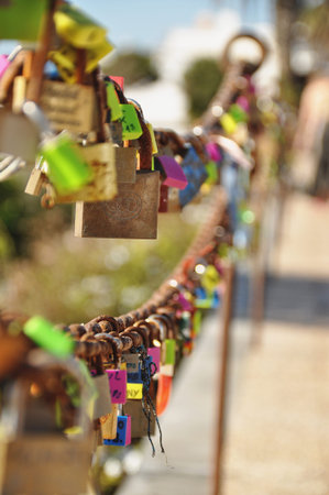 Colorful love locks on rusty chain in Lanzarote