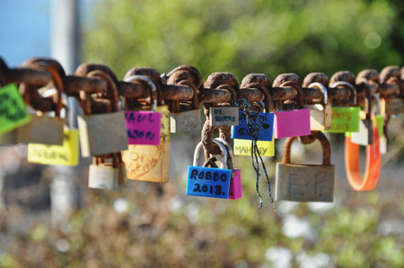 Colorful love locks on rusty chain in Lanzarote