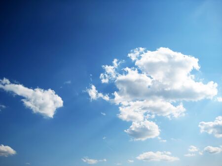 real dark blue sky with clouds and sunraysの写真素材
