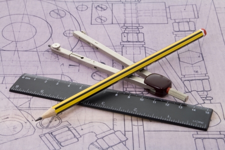 blueprint with pencil, ruler and dividers lying on itの写真素材