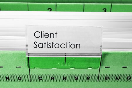 green hanging file folder labeled with Client Satisfaction