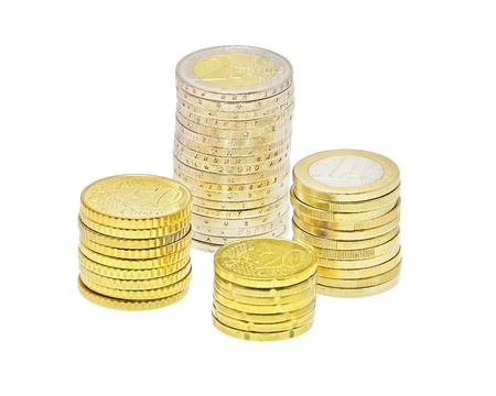 four stacks of euro coins isolated on white backgroundの写真素材