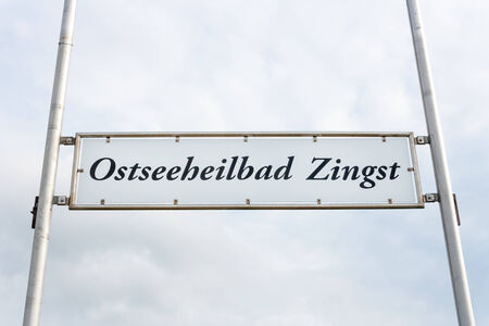 Zingst pier sign, cloudy skyの写真素材