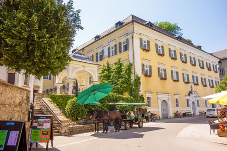 St. Wolfgang, Austria - June 23, 2014: The center of the village with a fiacre in front. Sankt...