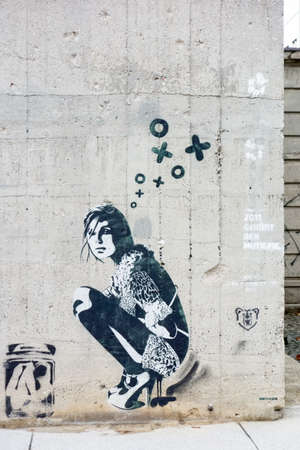 Berlin, Germany - October 26, 2013: Graffiti of a girl / woman on a concrete wall in Berlin.のeditorial素材