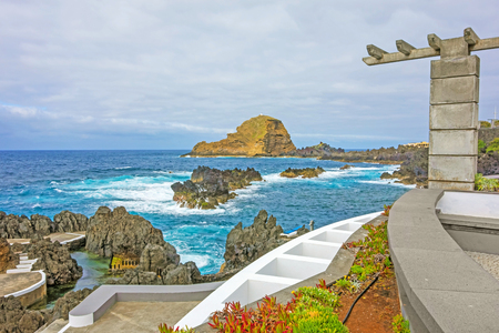 View from the natural lava rock pool in the village Porto Moniz to rock Ilheu Mole, Madeira, Portugalのeditorial素材