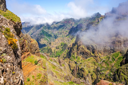 Hiking trail passage from mountain Pico Arieiro to Pico Ruivo, Madeira - colorful volcanic mountain landscapeの写真素材