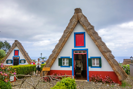 Santana, Portugal - June 7, 2013: Flower's related craft souvenir shop built like a typical triangular house, Island of Madeira.のeditorial素材