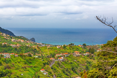 Madeira landscape near Faial and Porto da Cruz - view towards Atlantic Ocean over hills with housesの写真素材