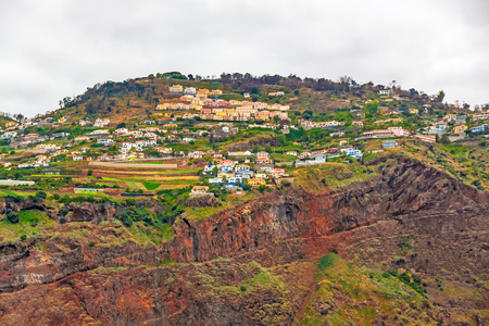 Colorful volcanic cliff coast between Funchal and Canico, Madeira Island, Portugalの写真素材