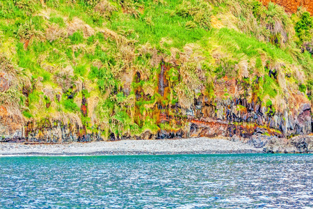 Colorful rocky cliff coast of Madeira between Jardim do Mar and Calhetaの写真素材