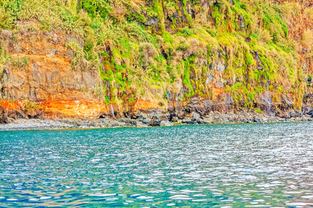 Colorful rocky cliff coast of Madeira between Jardim do Mar and Calhetaの写真素材