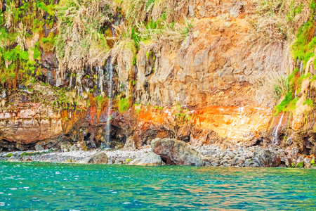 Colorful rocky cliff coast of Madeira between Jardim do Mar and Calhetaの写真素材