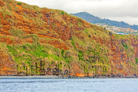 Colorful rocky cliff coast of Madeira between Jardim do Mar and Calhetaの写真素材