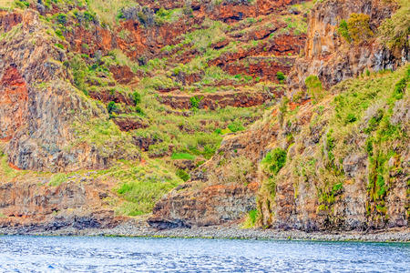 Colorful rocky cliff coast of Madeira between Jardim do Mar and Calhetaの写真素材