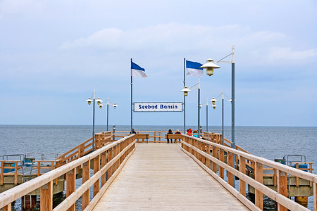 Bansin, Usedom, Germany - June 27, 2012: Pier of the baltic sea spa town Bansin - a famous tourist hotspot. Pier sign labeled with sea spa town Bansin (Seebad Bansin).のeditorial素材