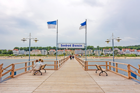 Bansin, Usedom, Germany - June 27, 2012: Pier of the baltic sea spa town Bansin - a famous tourist hotspot. Pier sign labeled with sea spa town Bansin (Seebad Bansin).のeditorial素材