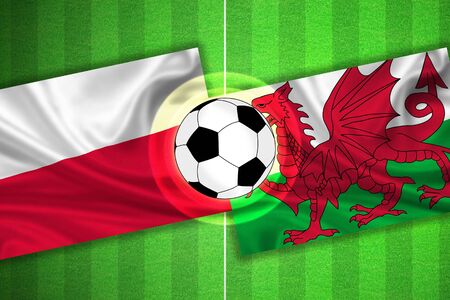 green Soccer / Football field with stripes and flags of poland - wales, and ball.の写真素材