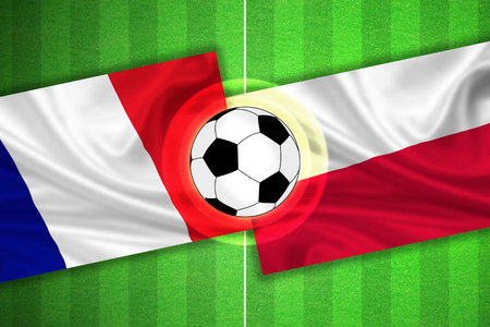 green Soccer / Football field with stripes and flags of france - poland, and ball.の写真素材
