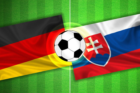 green Soccer / Football field with stripes and flags of germany - slovakia, and ball.の写真素材