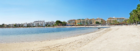 Alcudia, Majorca, Spain - June 26, 2008: Beach panorama of Alcudia with hotels, promenade and beach with water of mediterranean sea in frontの写真素材
