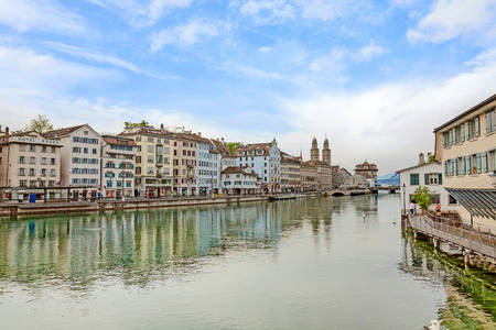 Zurich, Switzerland - June 10, 2017: Downtown view of Zurich from bridge Rudolf-Brun-Brucke, Grossmunster, town hall and river Limmat in front.のeditorial素材