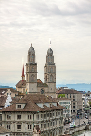 Zurich, Switzerland - June 10, 2017: The Grossmunster with town hall in front. It is a Romanesque-style Protestant church in Zurich, Switzerland. View from park Lindenhof.の写真素材