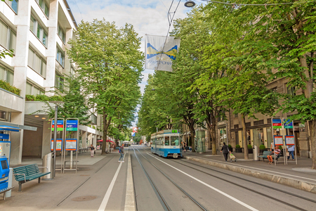 Zurich, Switzerland - June 10, 2017: Shopping promenade called Bahnhofstrasse, inner city of Zurich. Tram / train in front.のeditorial素材