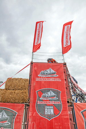 Nurburg, Germany - May 20, 2017: Fishermen's Friend Strongman RUN at race track Nurburgring - straw bale obstacleのeditorial素材